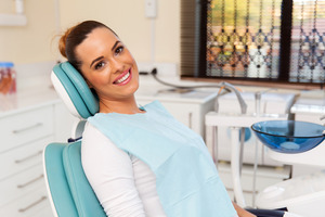 Female dental patient leaning back in dental chair